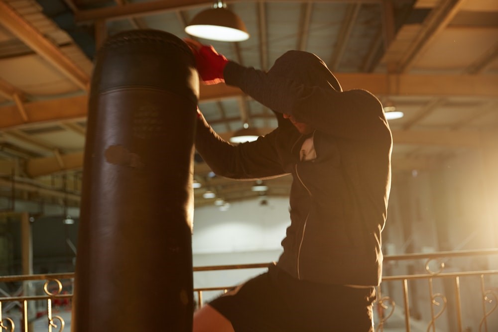 A boxer training with a punching bag