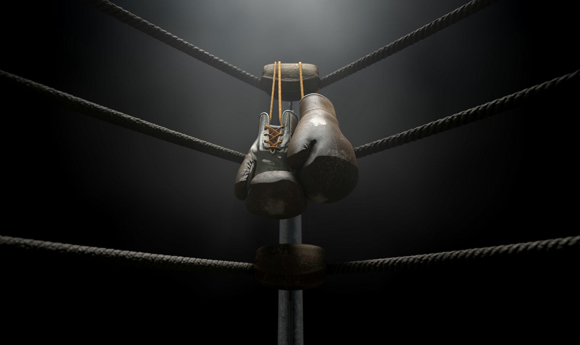 Boxing gloves handing in the corner of the ring.