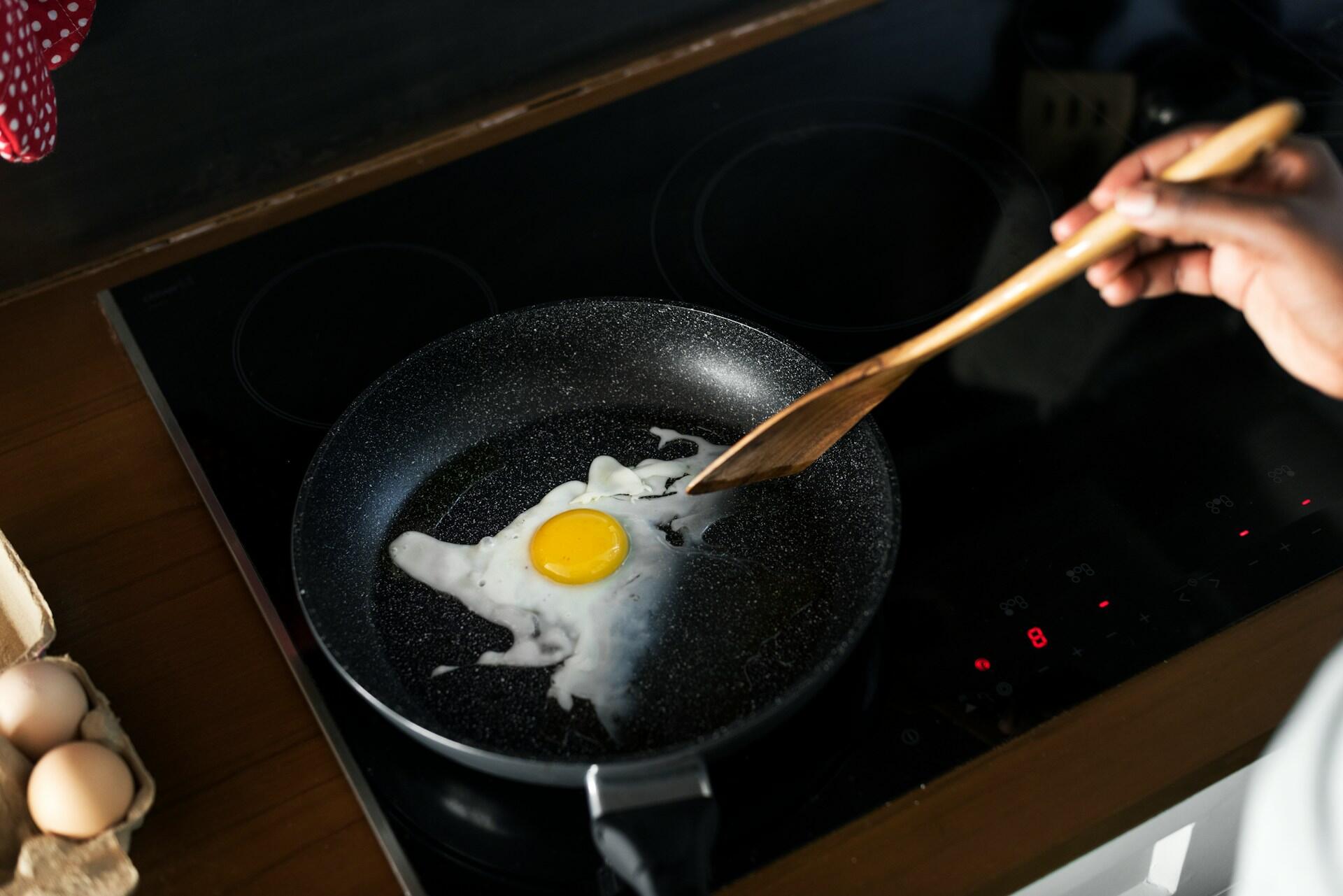 Someone frying an egg.