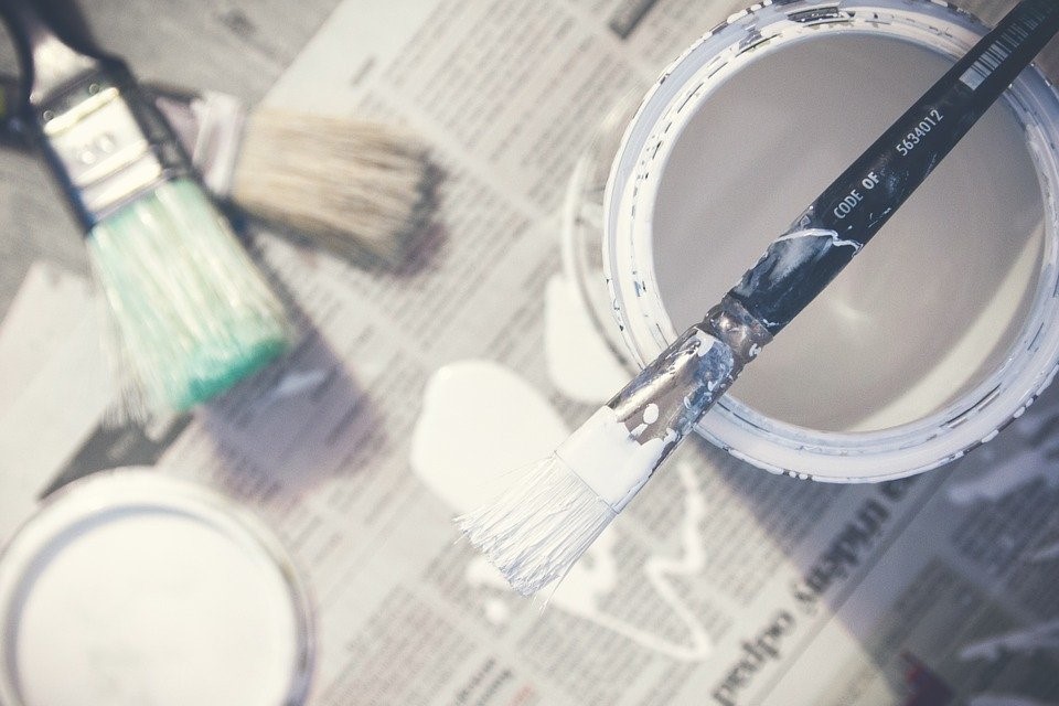 Paint bucket along with paintbrushes
