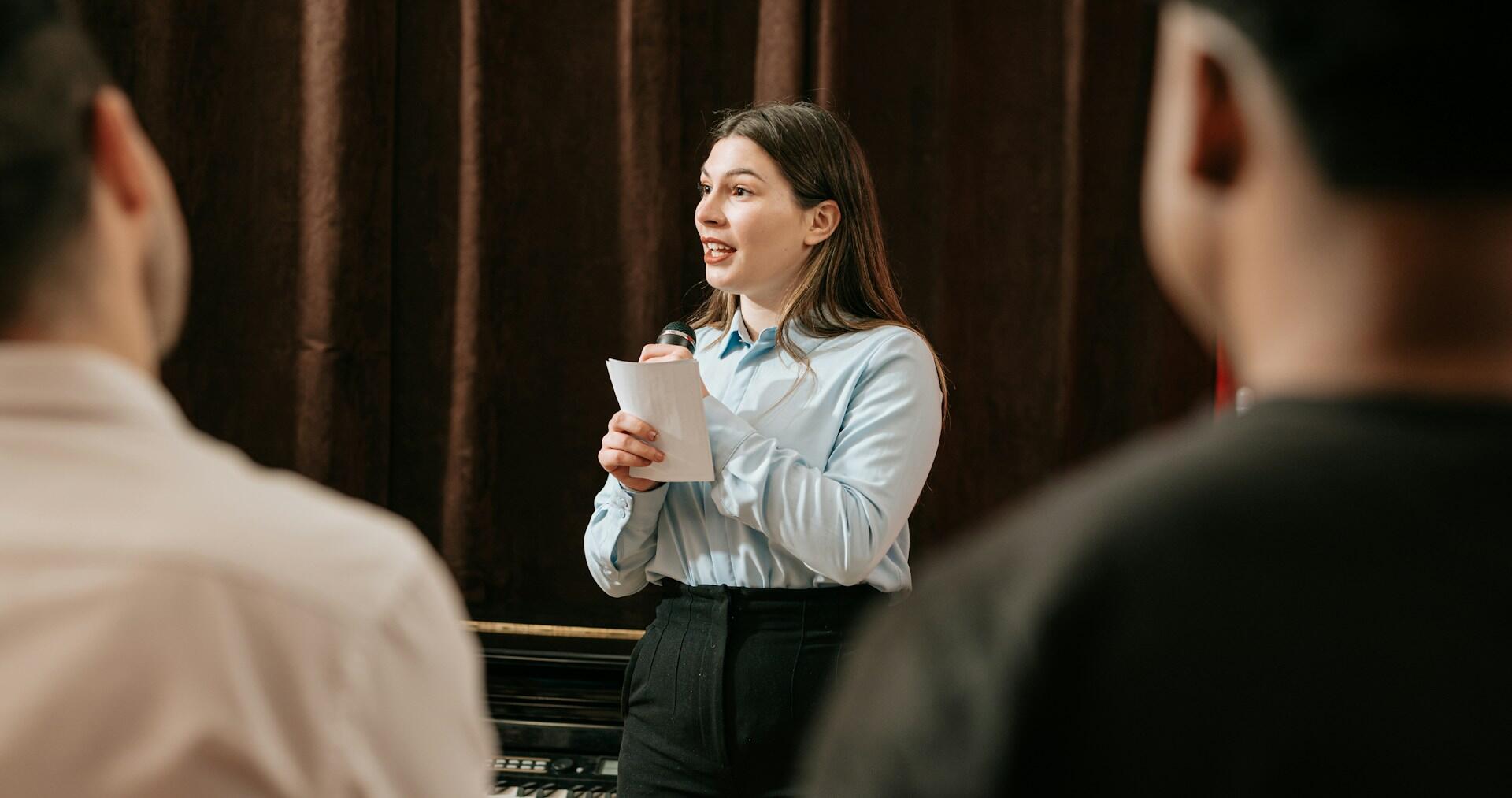 A drama teacher in front of two students.