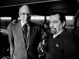 Maurice Béjart standing next to a gentleman in glasses and a suit.