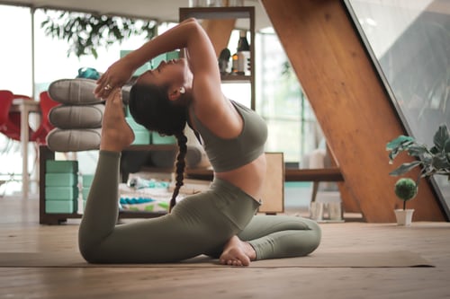 A woman practicing yoga on a mat in isolation