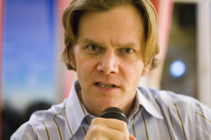 Close up of Taylor Mali with a microphone.