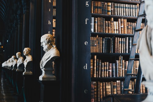 Busts of notable historical figures are lined up in a library