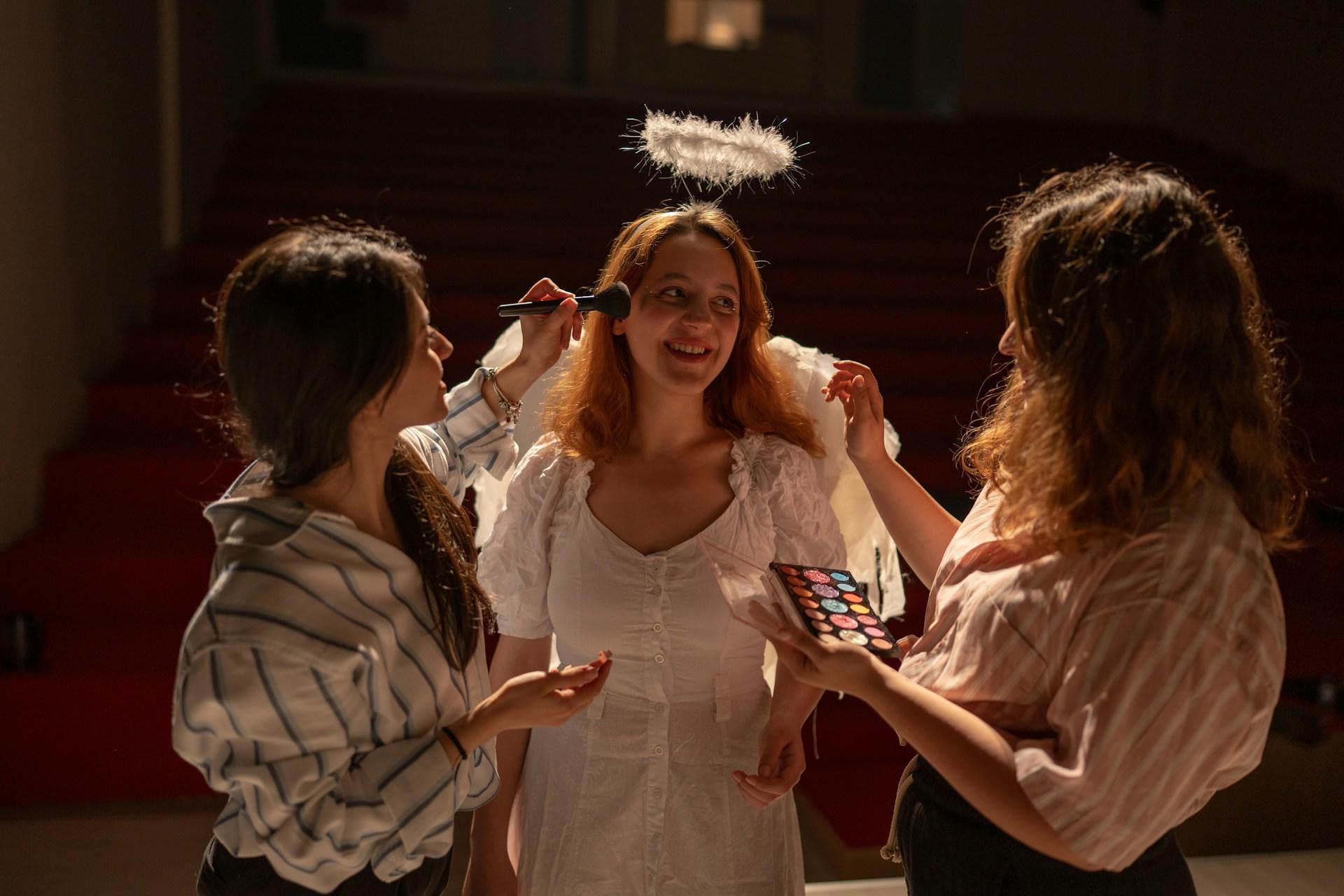 An actress and two makeup artists