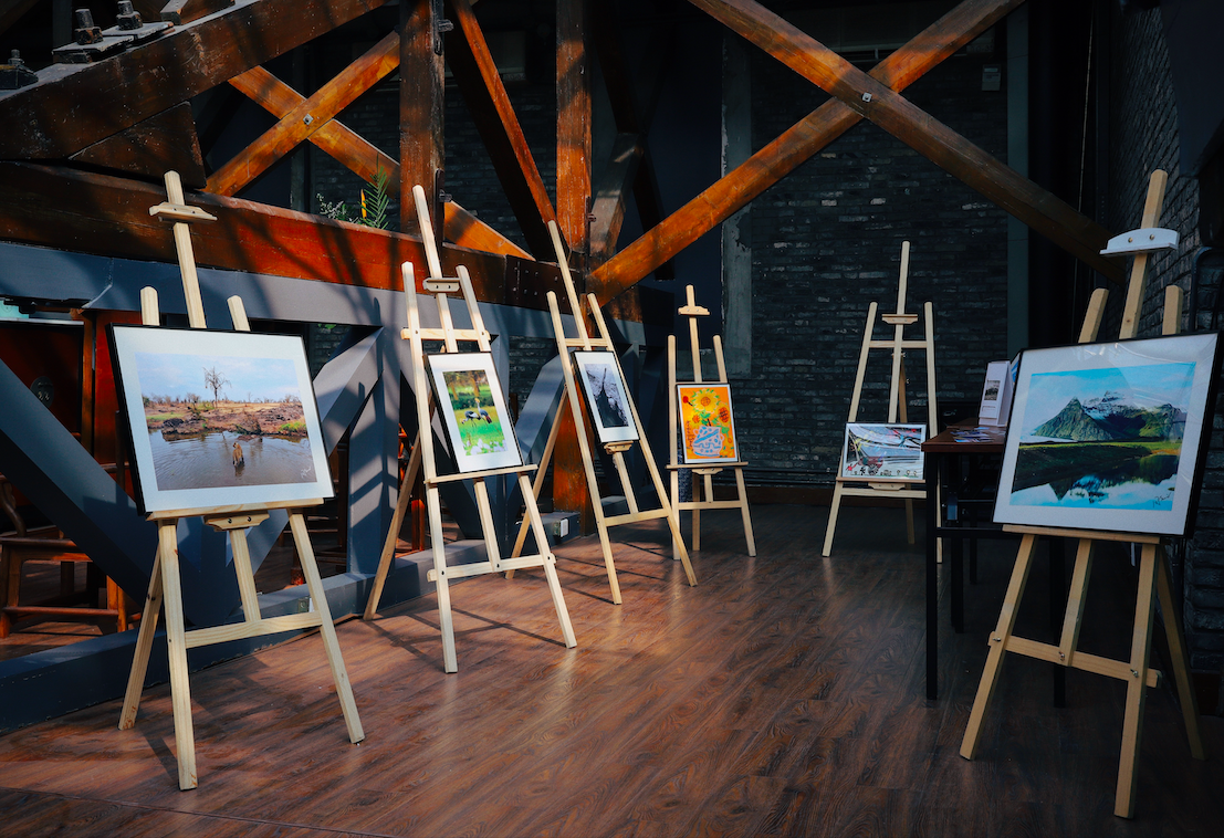 Studio with many paintings sitting on easels.