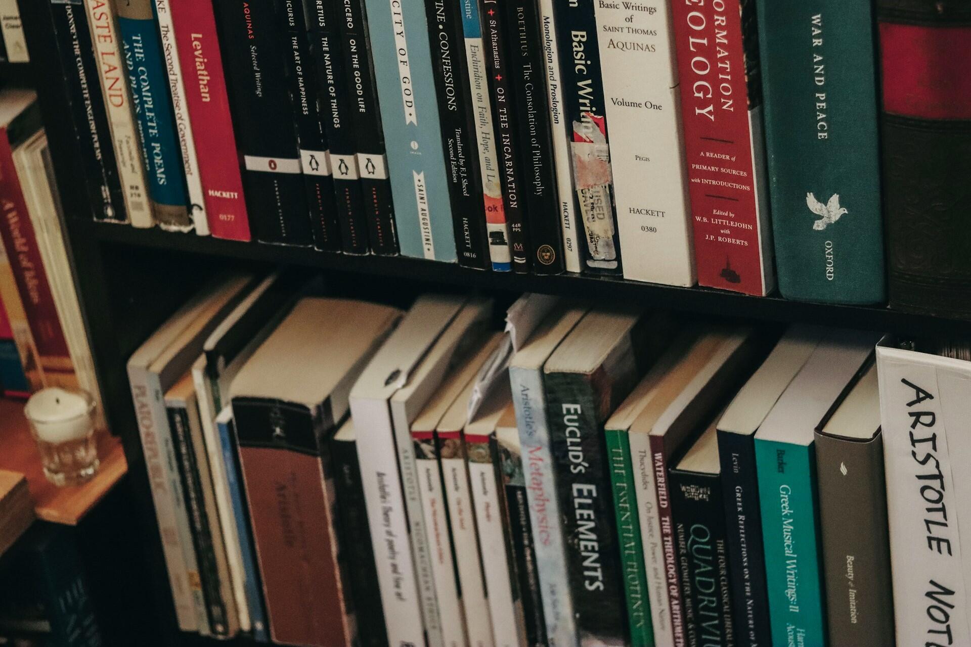 Shelf of books including a copy of Euclid’s Elements