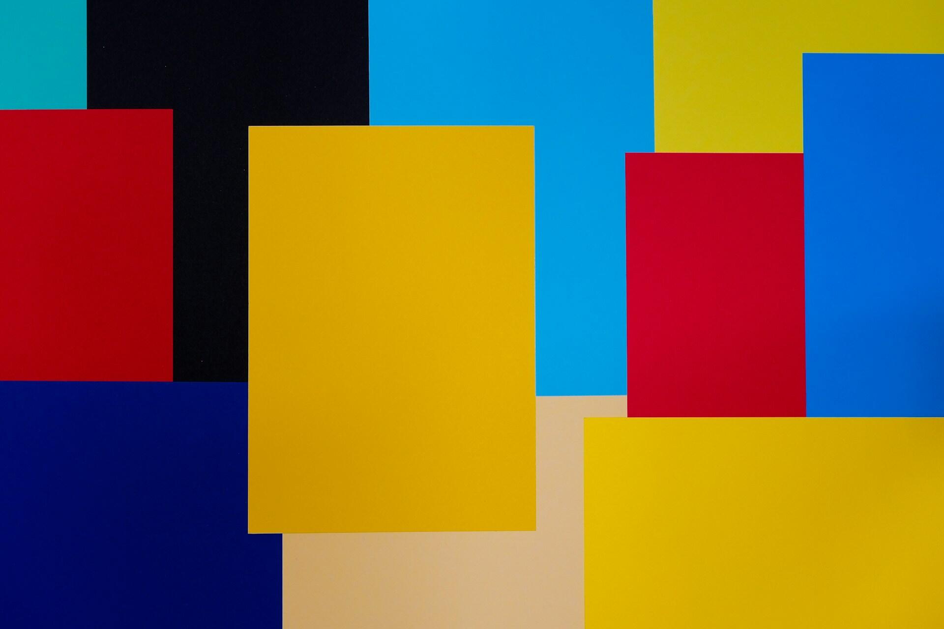 Colorful geometric squares arranged on a blue and yellow background