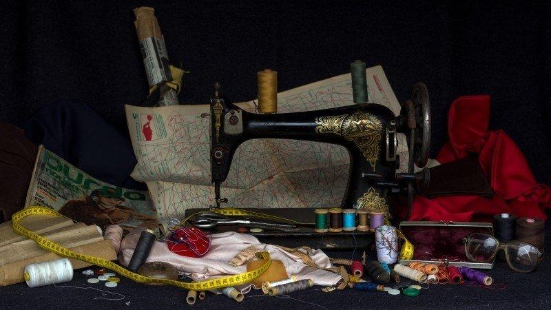 Image of a vintage sewing machine and sewing equipment