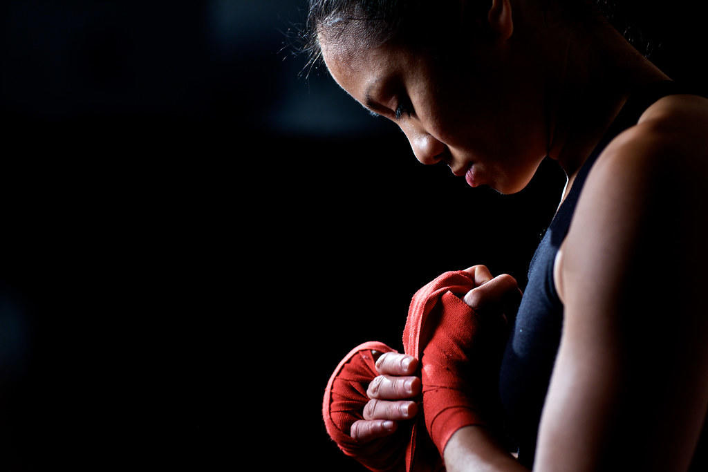 Boxer putting on boxing gloves