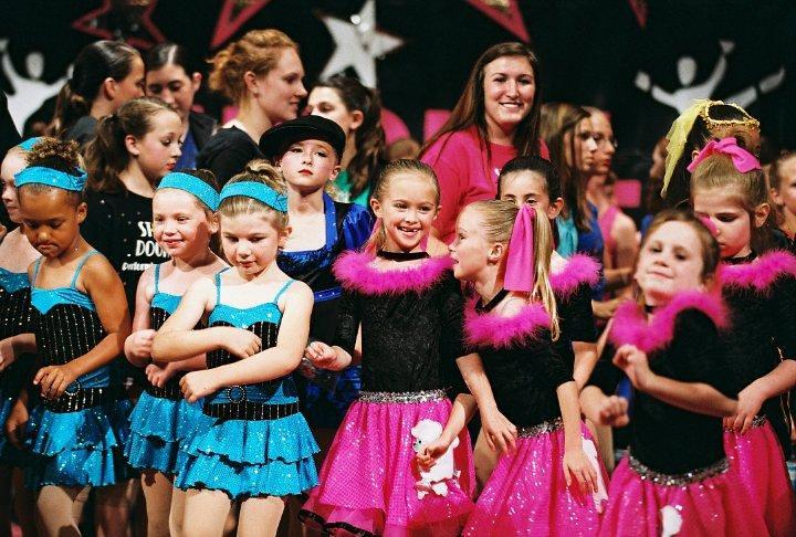 Children performing on stage in costume