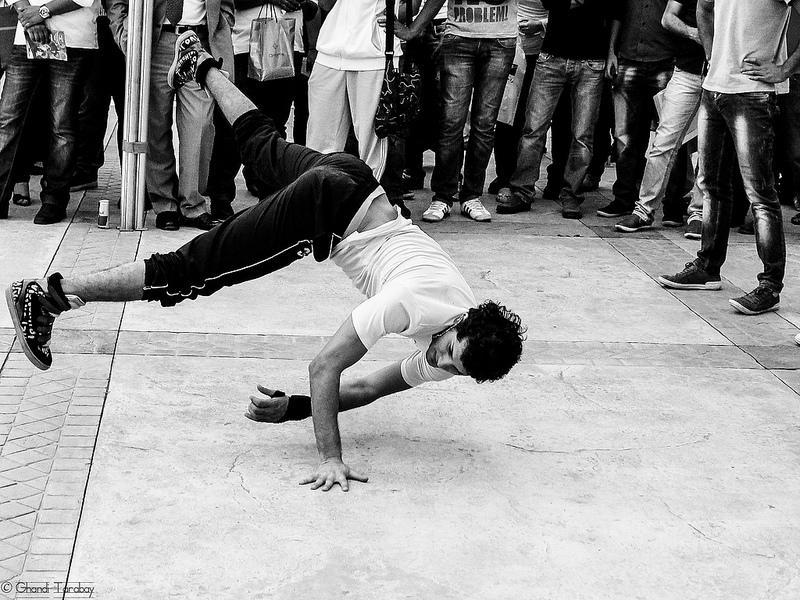 Black and white photo of a street breakdancer