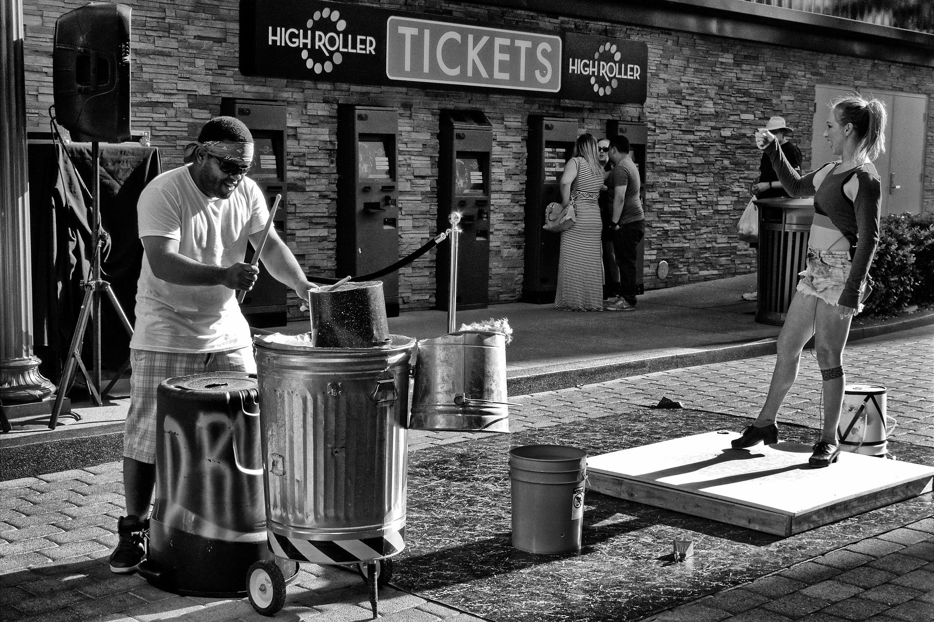 Man playing bucket drums outside