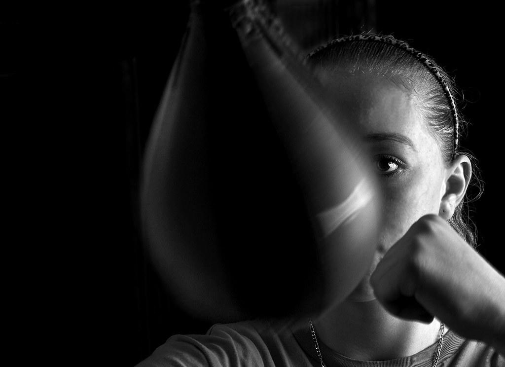 black and white photo of woman boxing