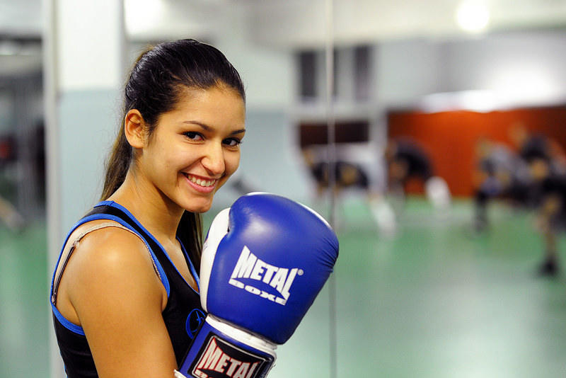 woman wearing blue boxing gloves