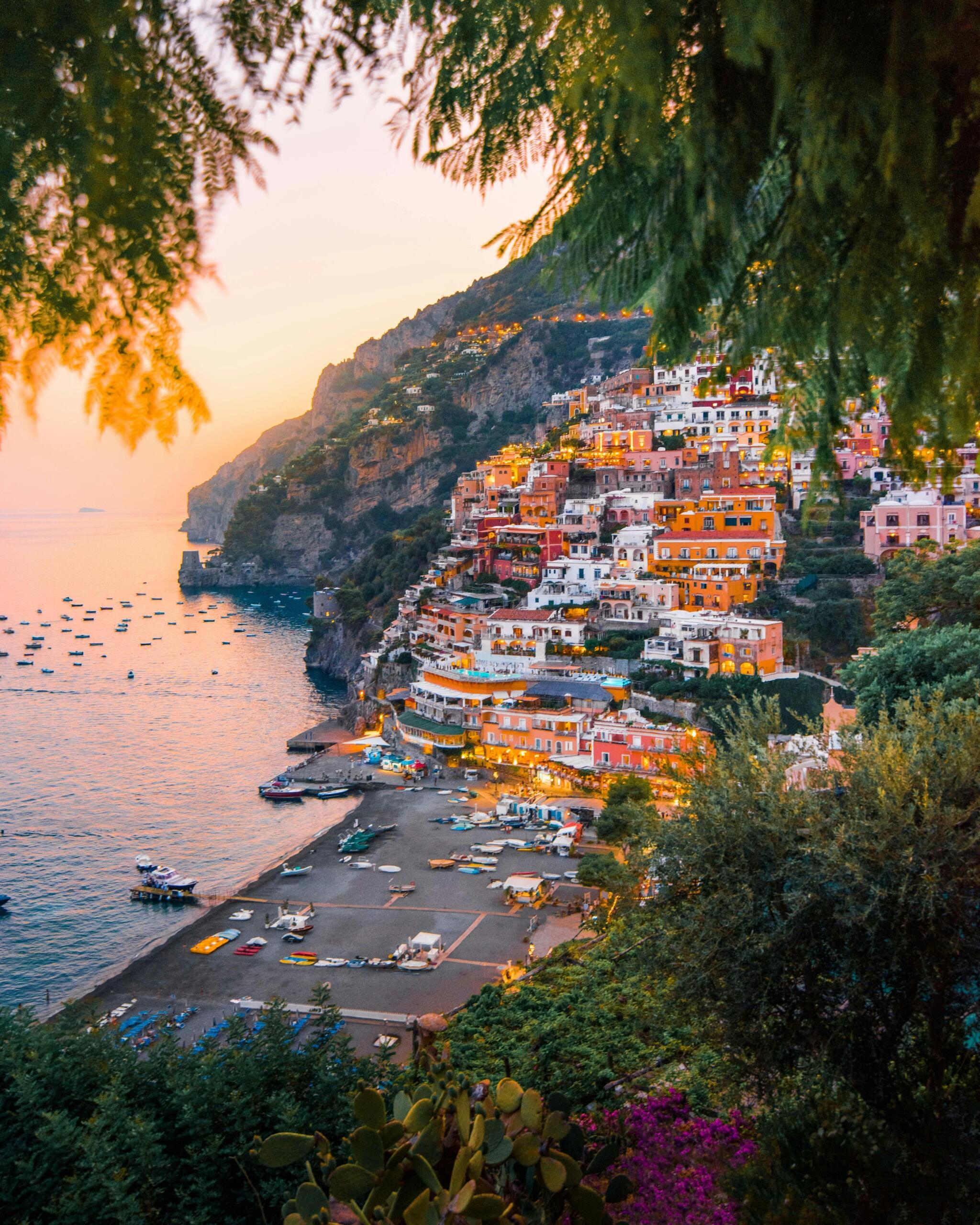 A vibrant cliffside village in Italy with colorful houses overlooking the sea.