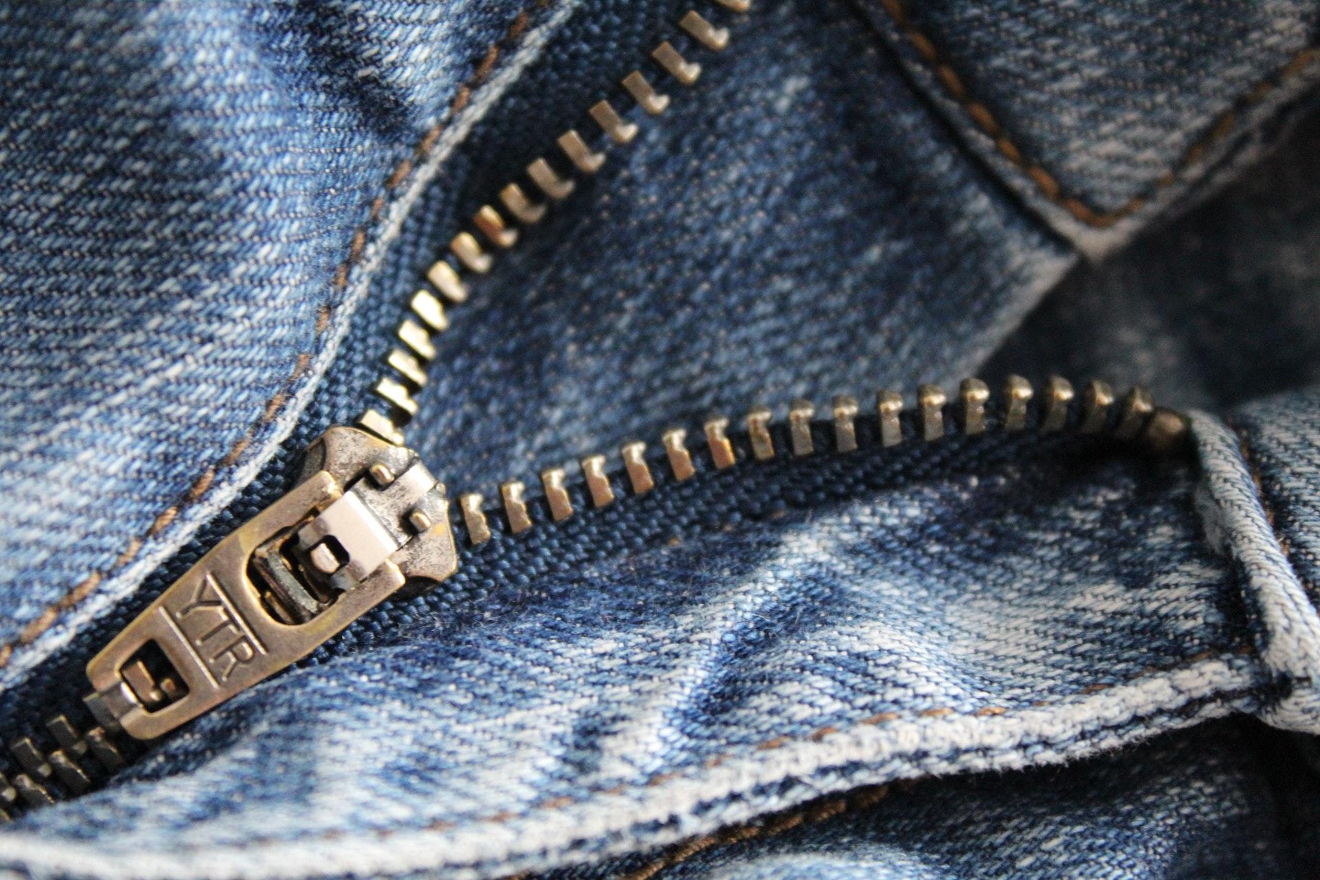 Closeup of zippers on blue jeans.