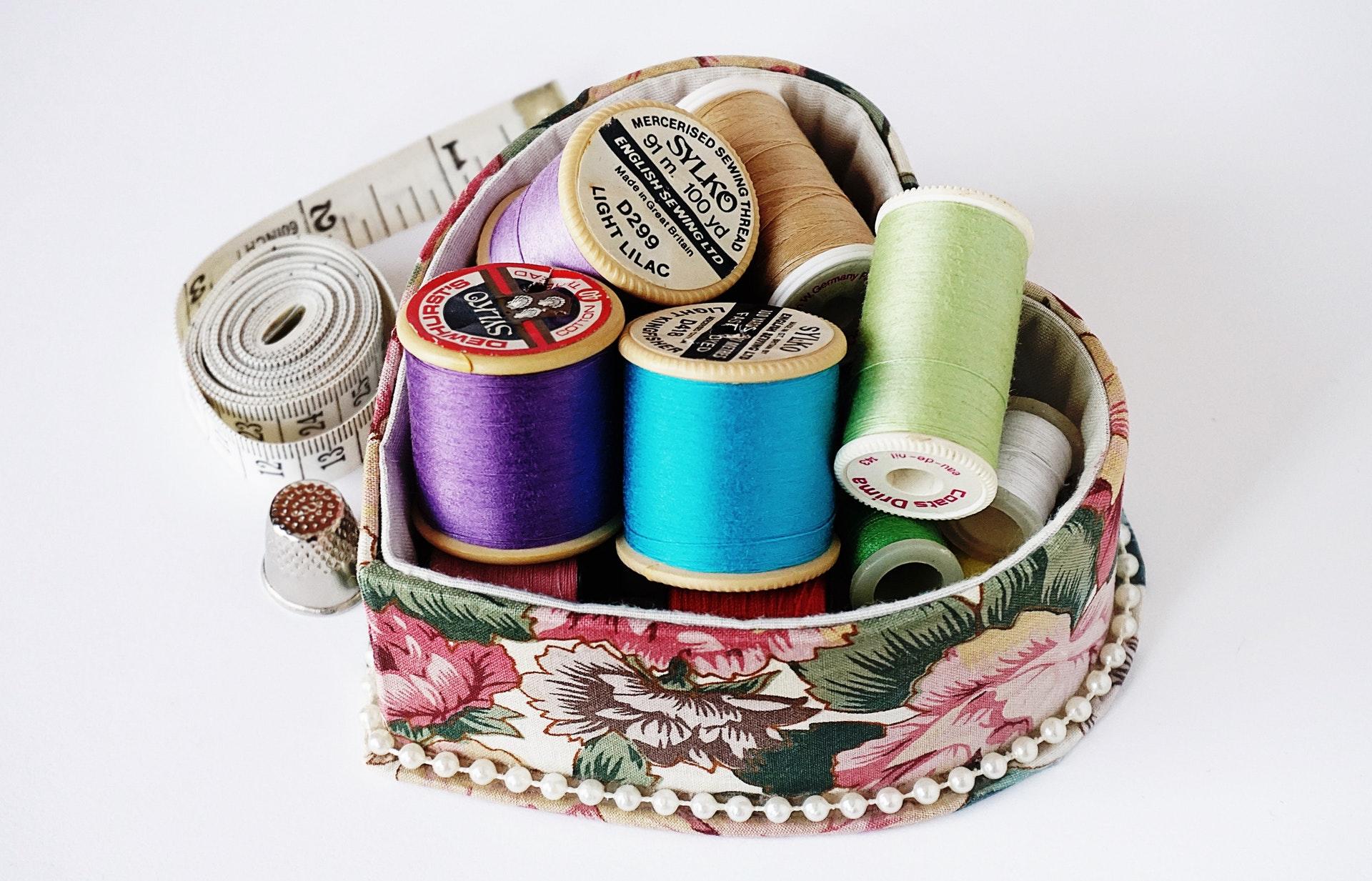 Colorful thread in a heard-shaped case.