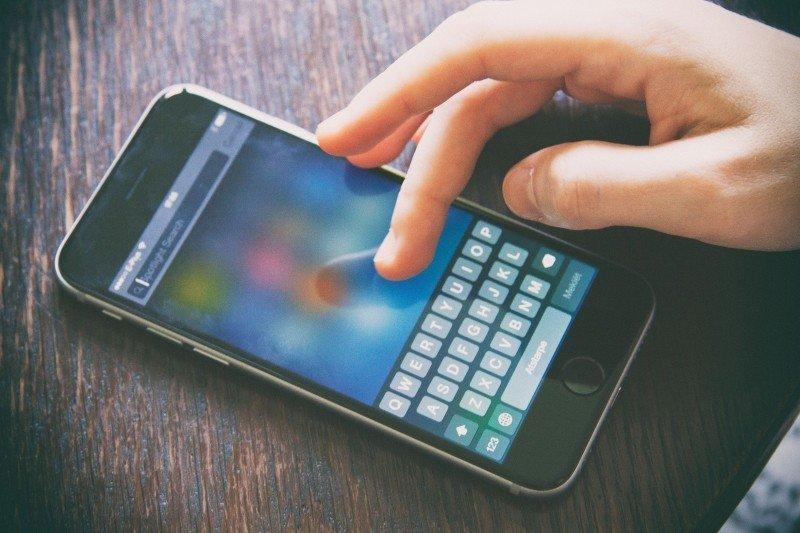 A student searches on their iPhone. 