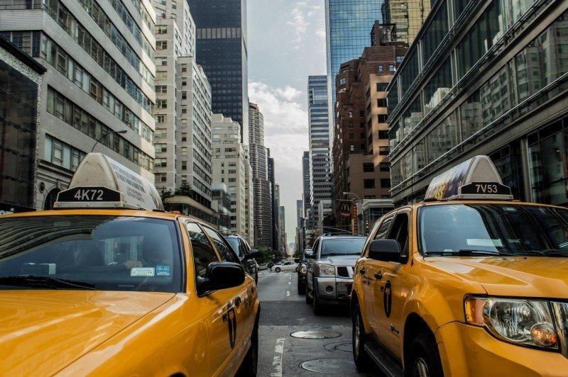 Yellow taxis wait in the busy New York traffic.