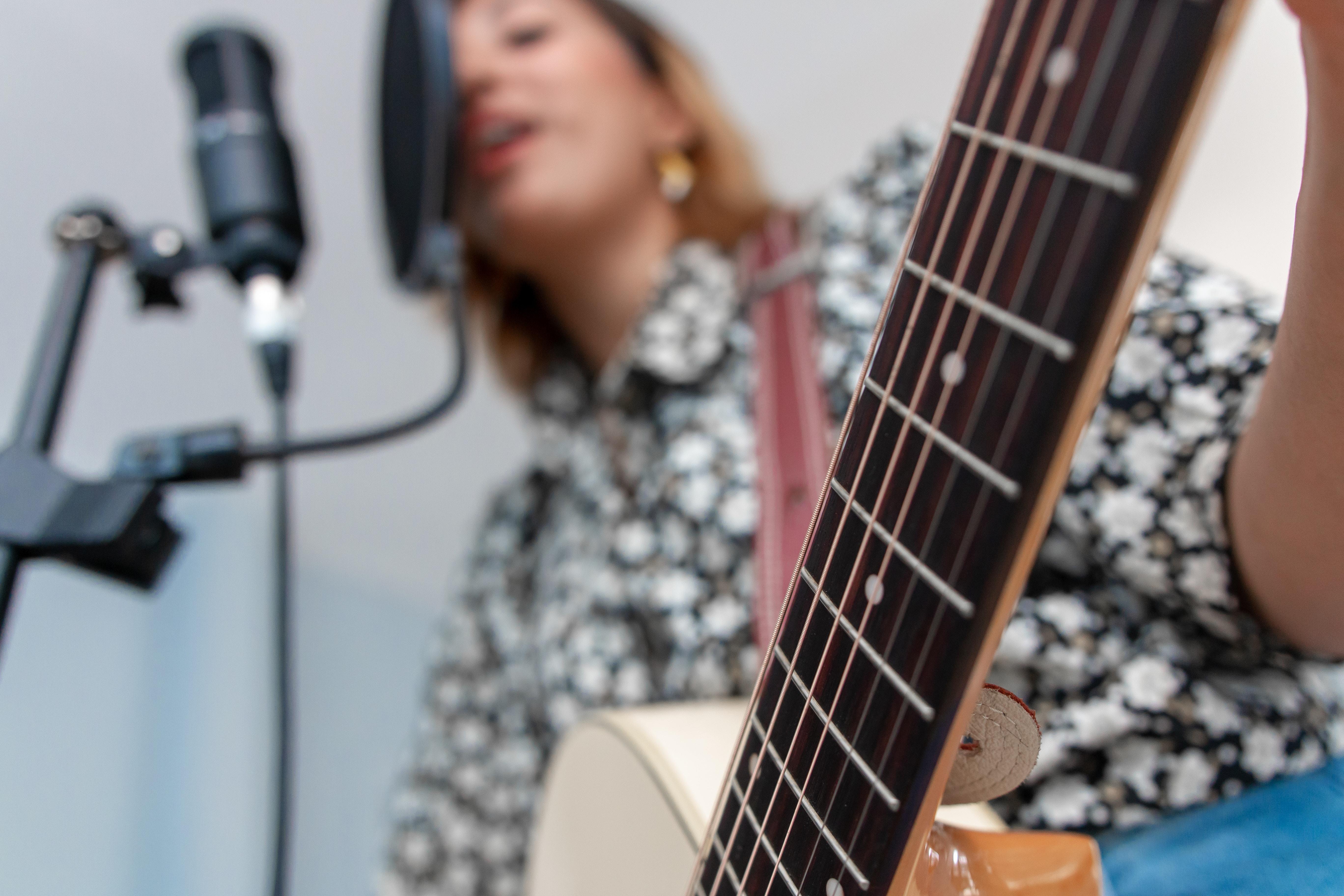 Woman recording and playing the guitar
