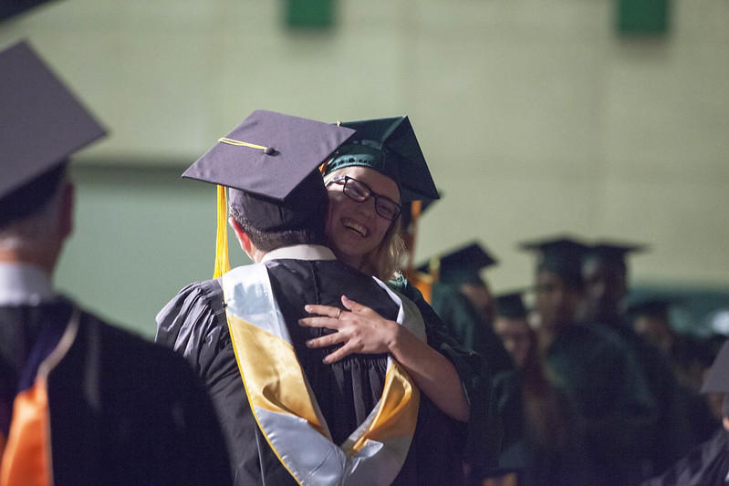 A student receives her degree certification.