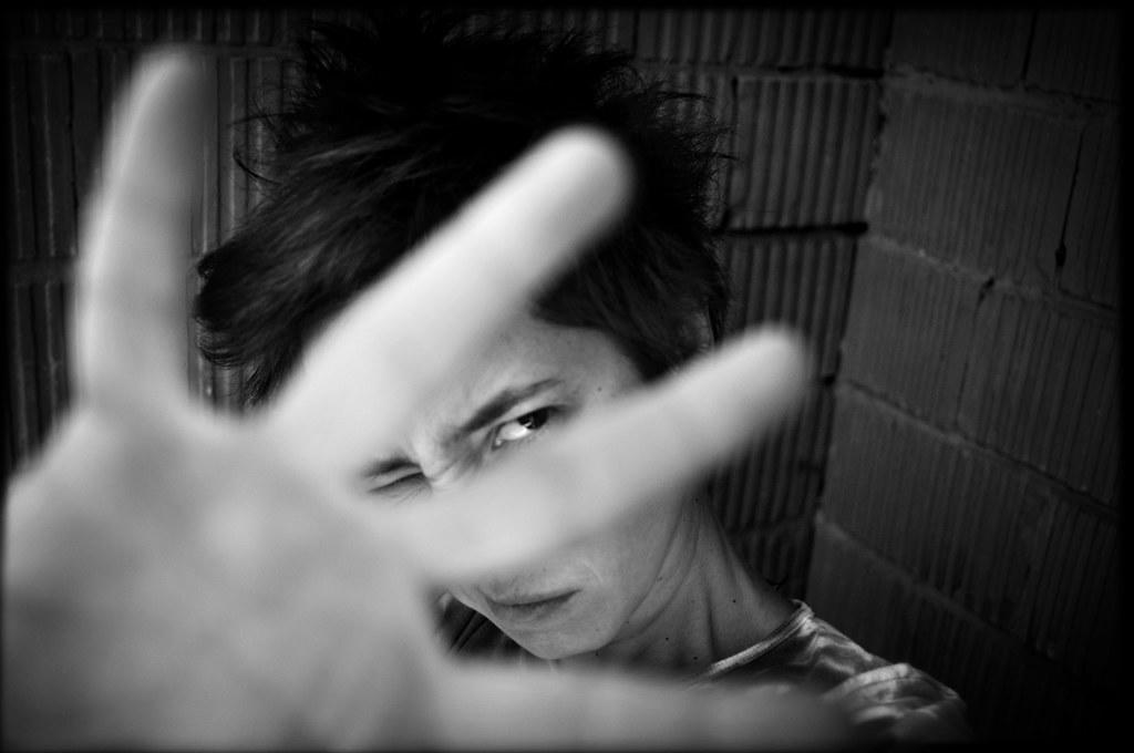 A student raises her four fingers.