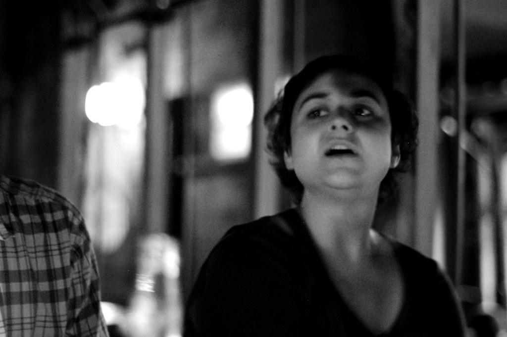 A woman practices singing at home.