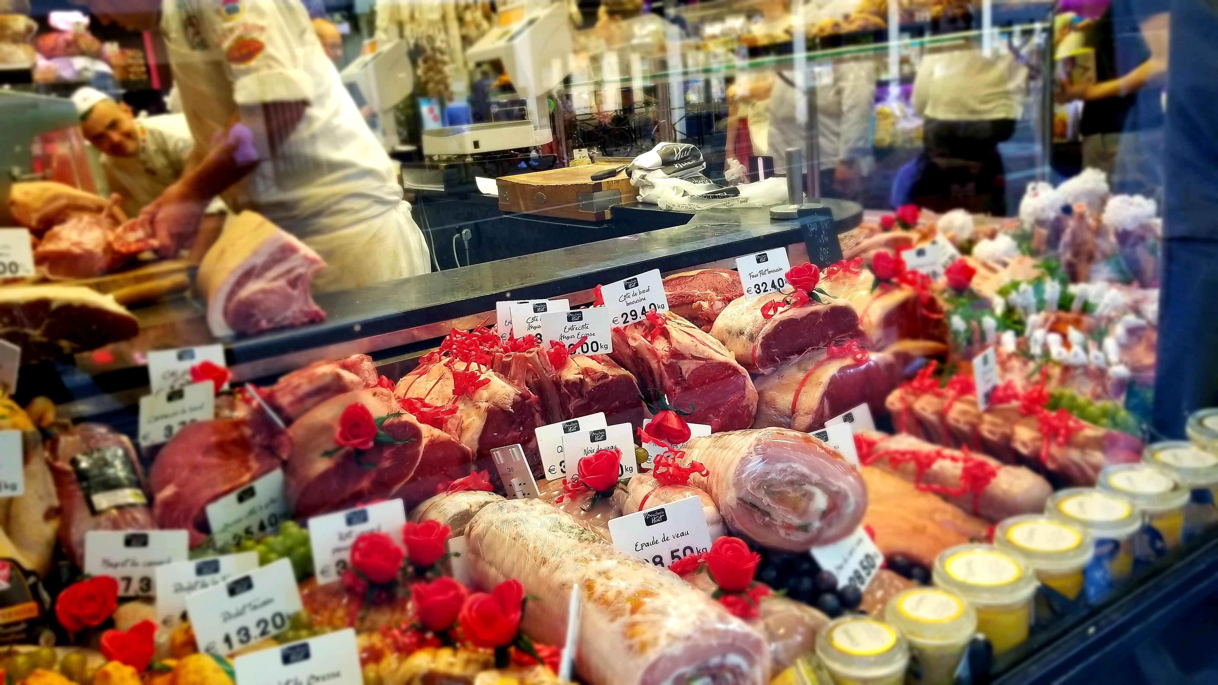 A variety of meats on display at a store.