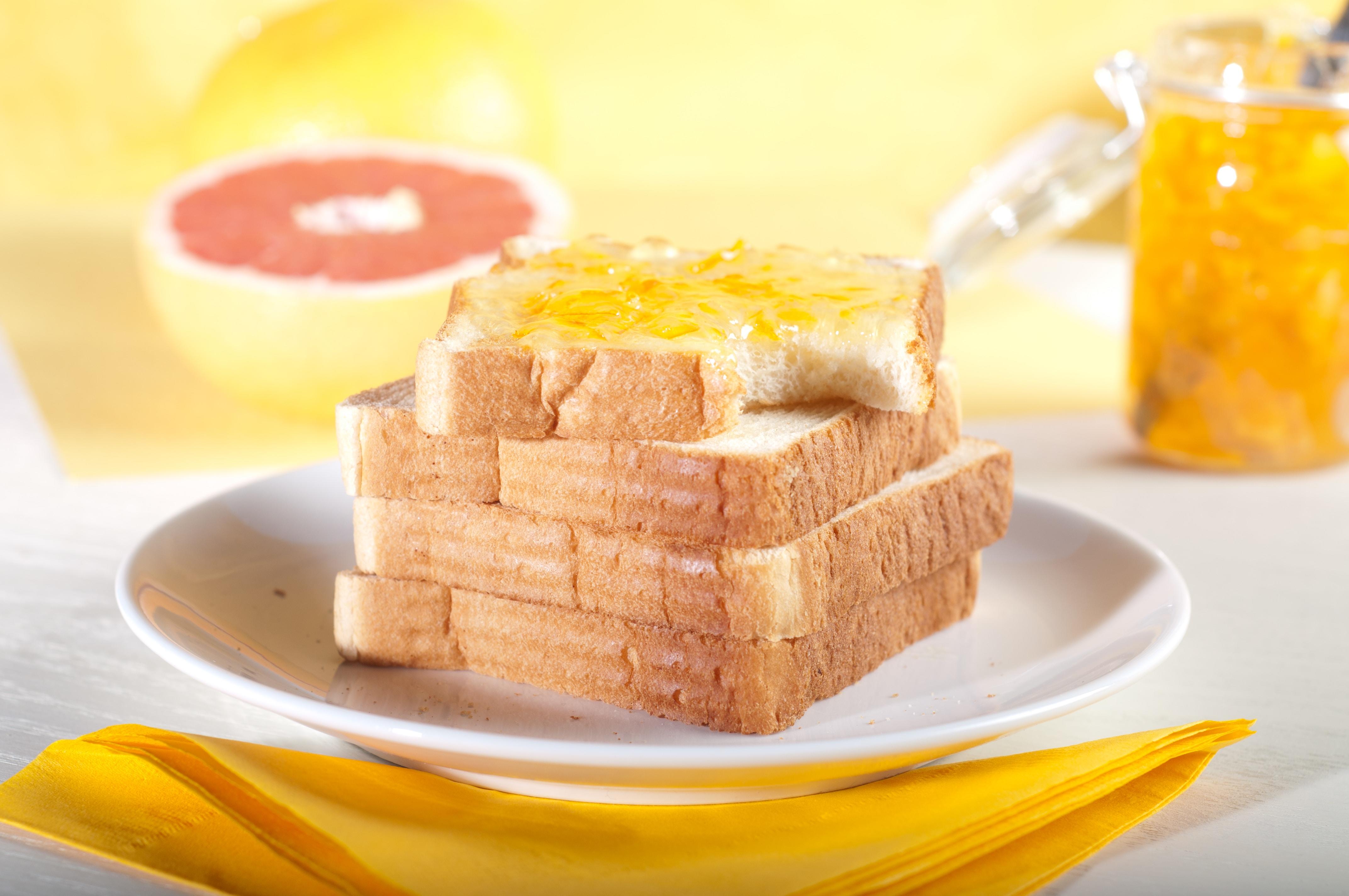 A stack of toast sitting on a white plate.