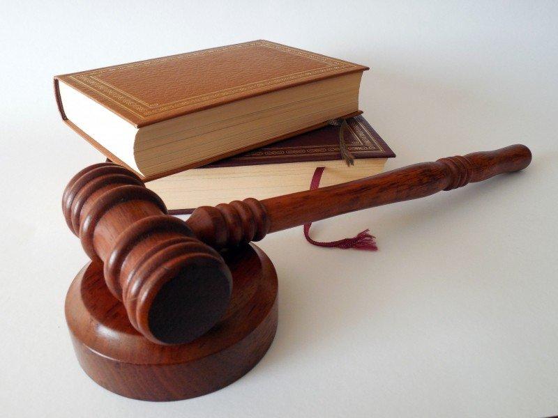 A judges hammer with two books on law