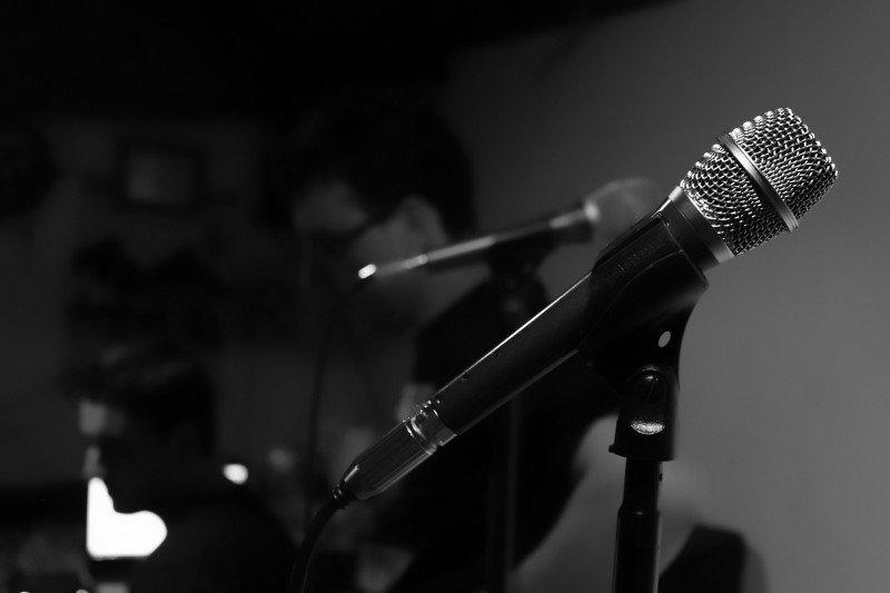 A dark shot of two microphones.