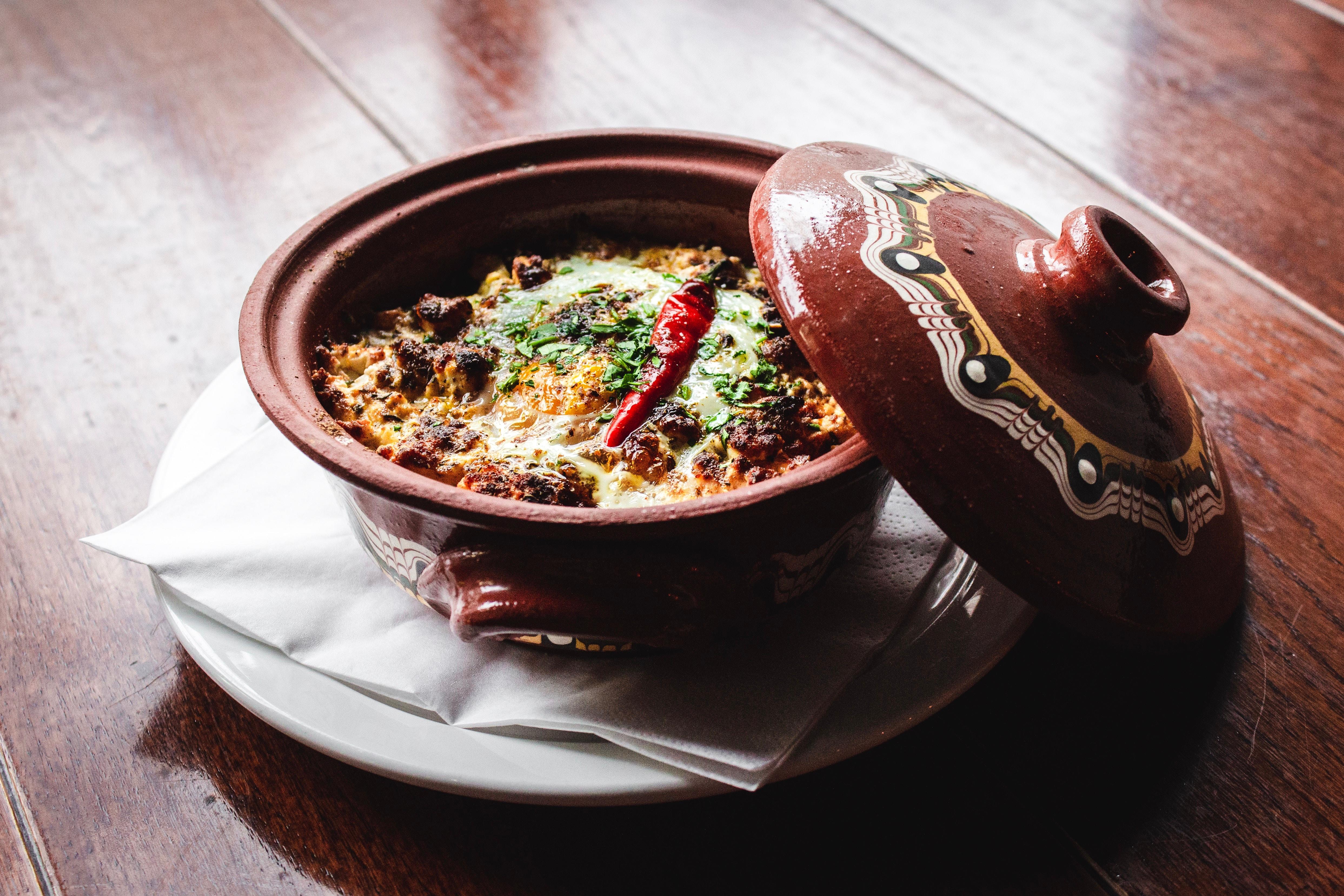 Bowl of food sitting in a ceramic pot.
