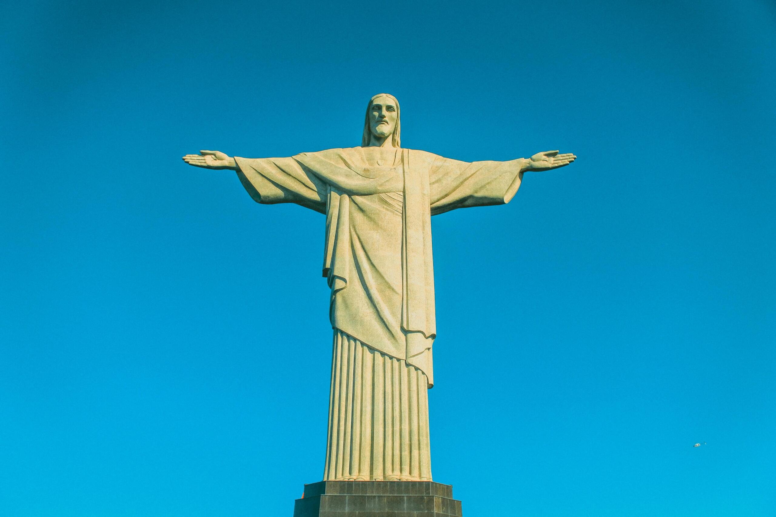 Christ the Redeemer with the blue sky behind the statue.
