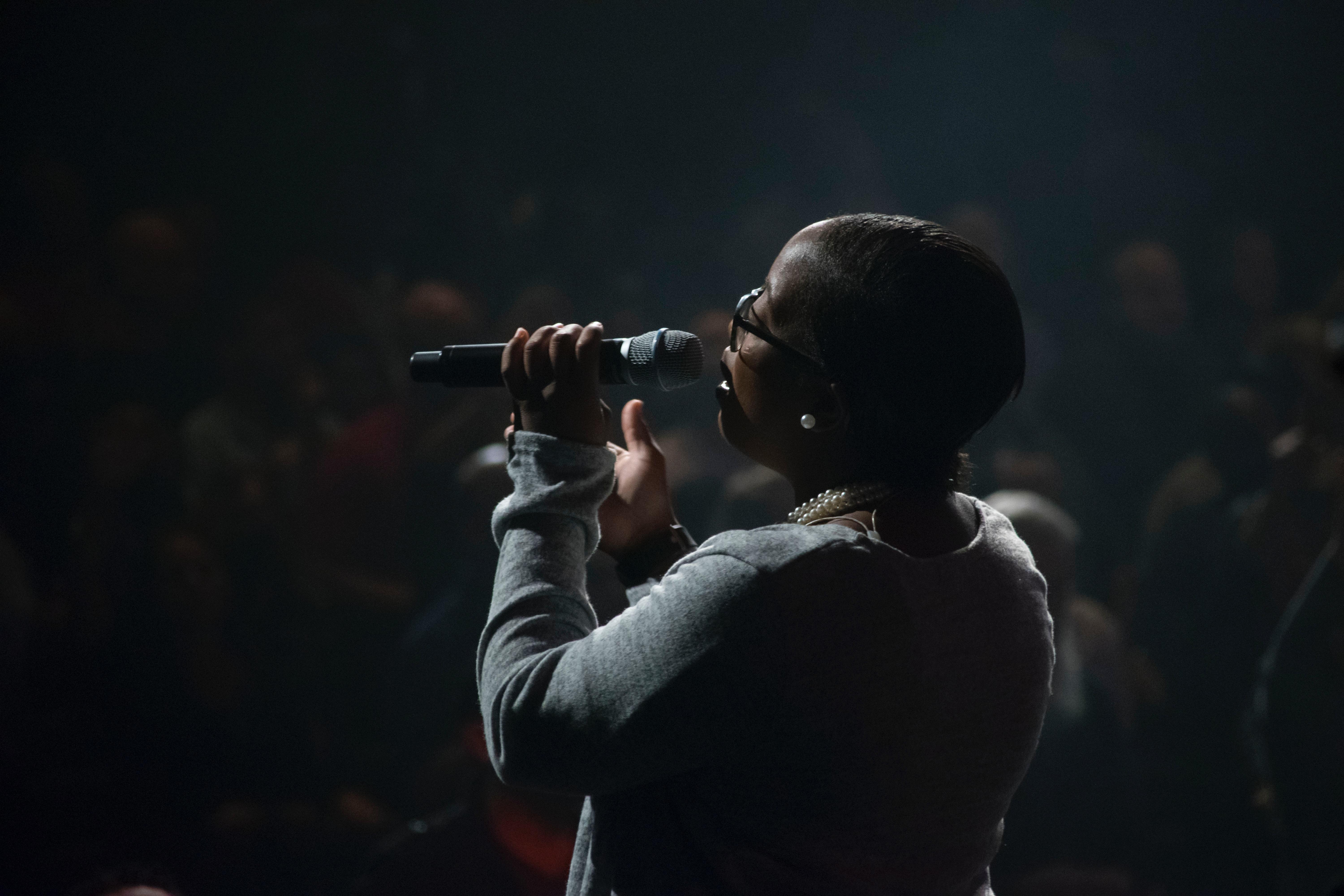 Woman performing slam poetry using a microphone