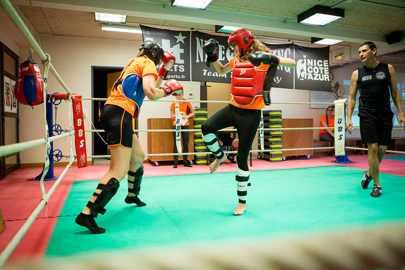 Women practicing to box with protective gear