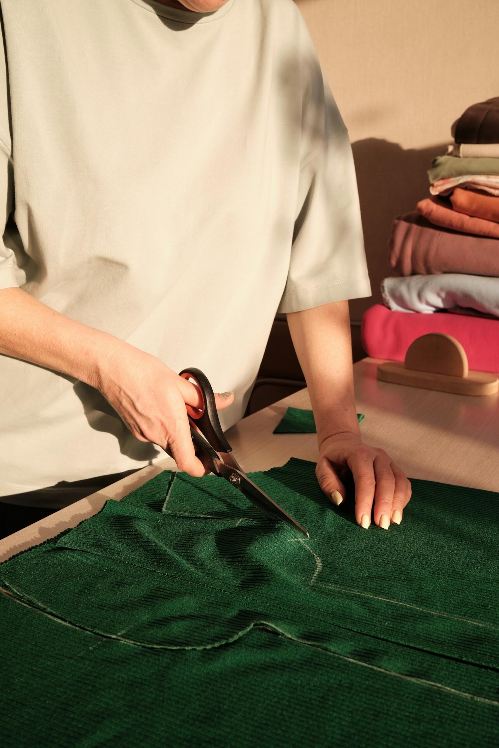 person cutting fabric according to a pattern