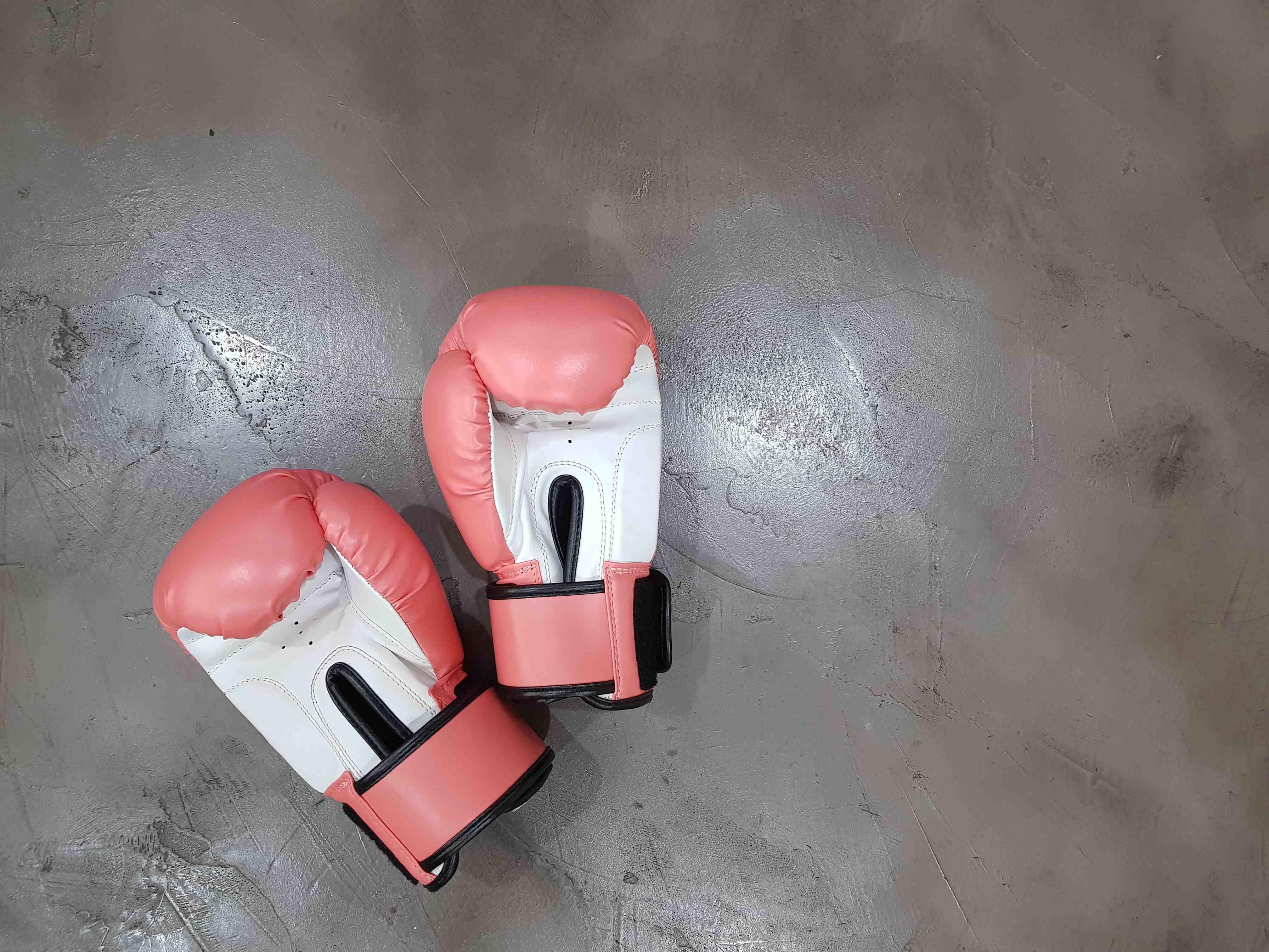 pink boxing gloves laying on the floor