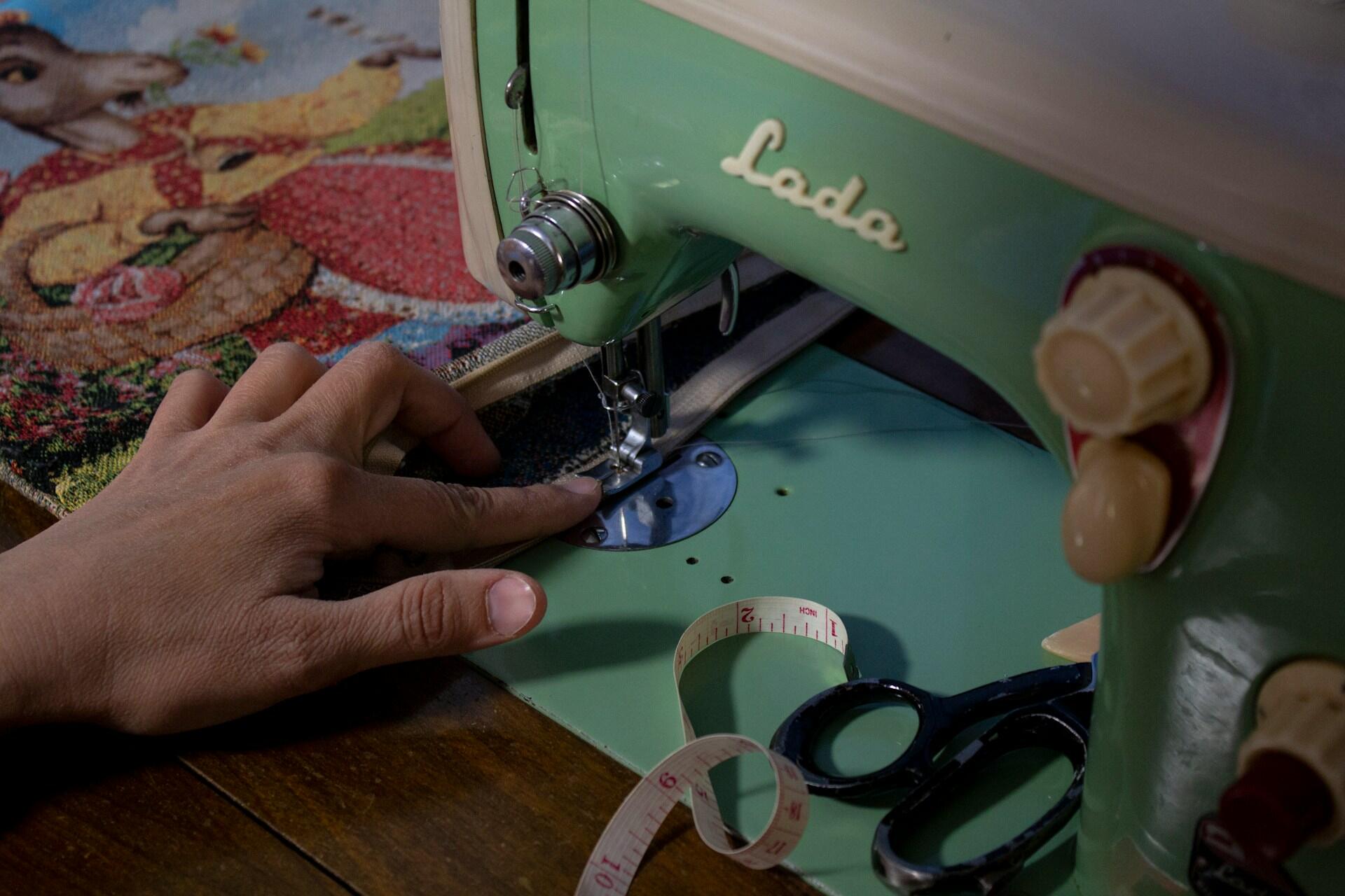 person using a vintage sewing machine