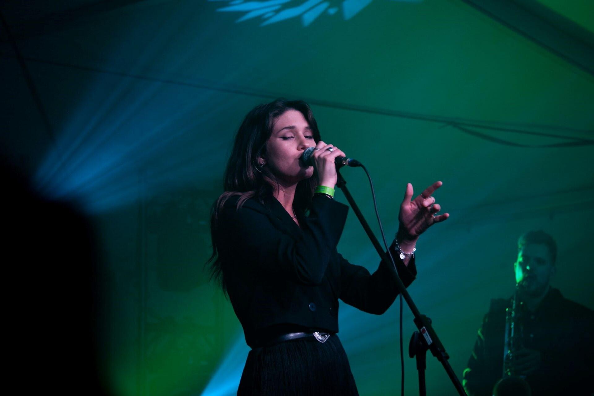 A woman singing on stage.