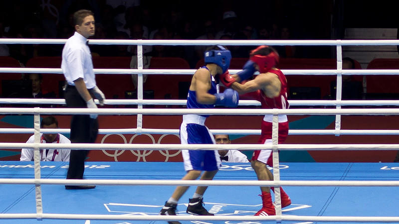 Two men in a boxing competition with savate boots