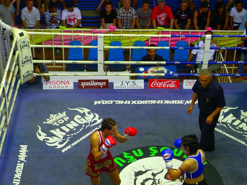 Two women competing in thai boxing