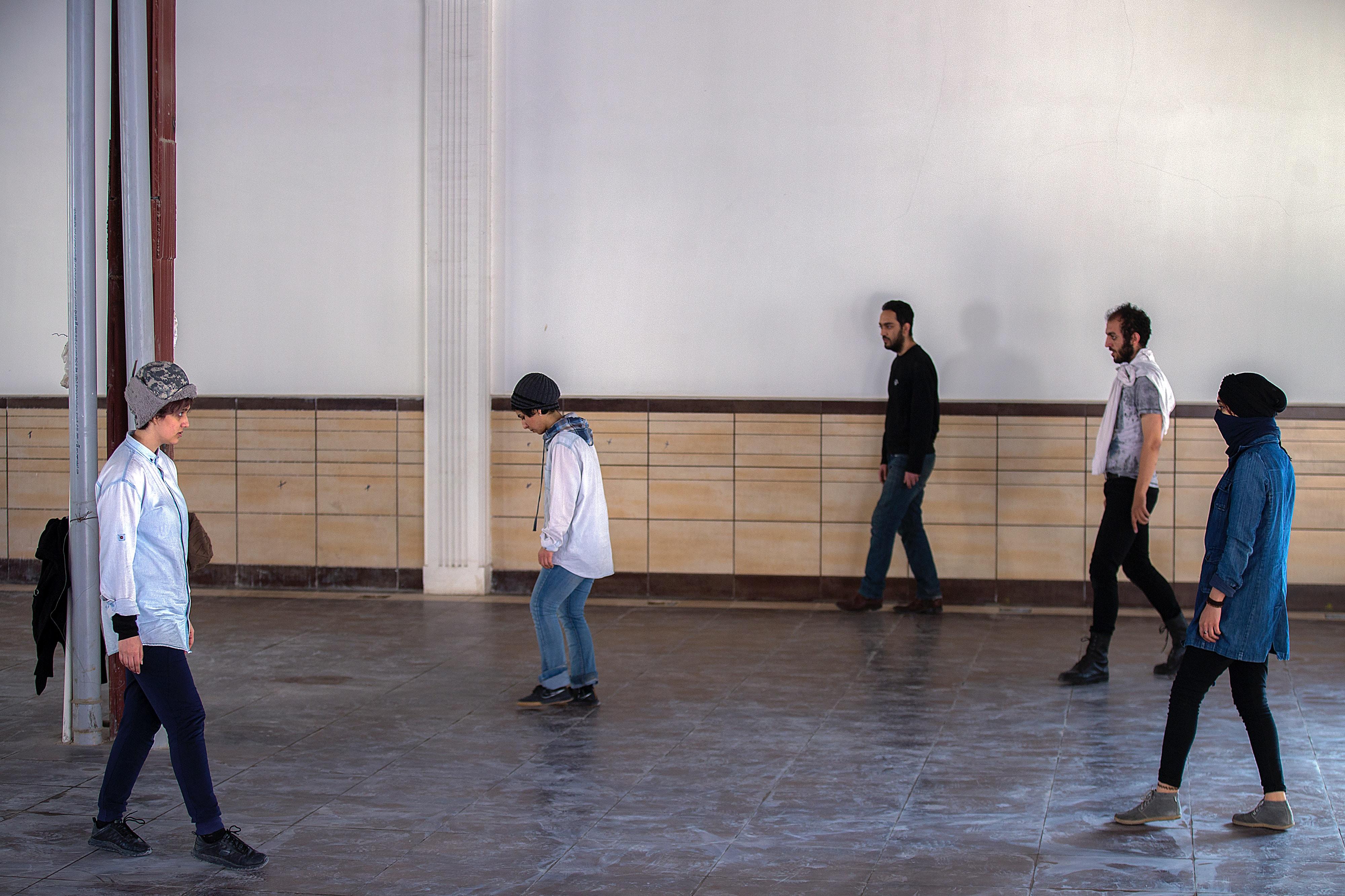People walking around in an acting class.
