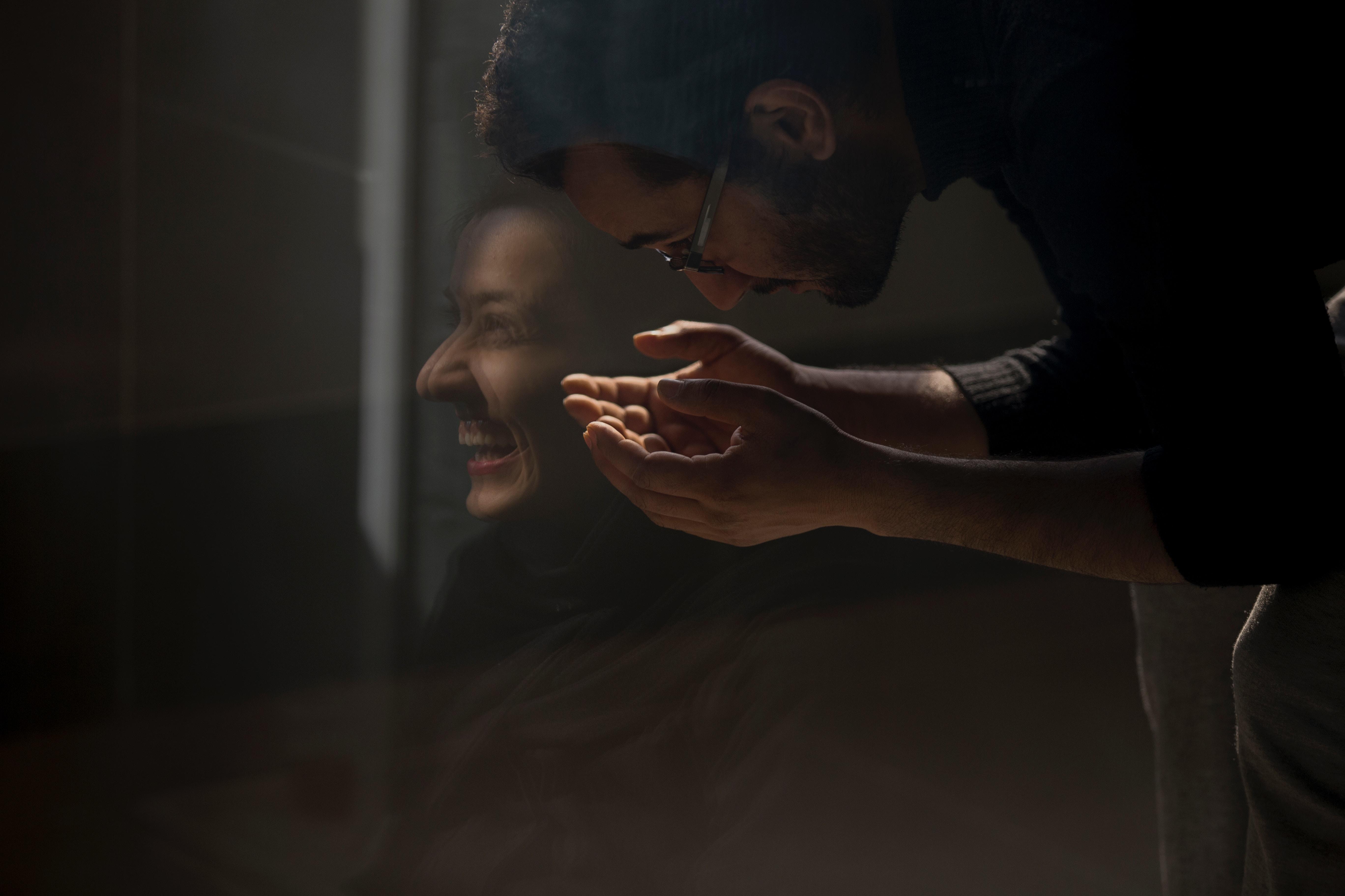 Man holding his head in his arms.