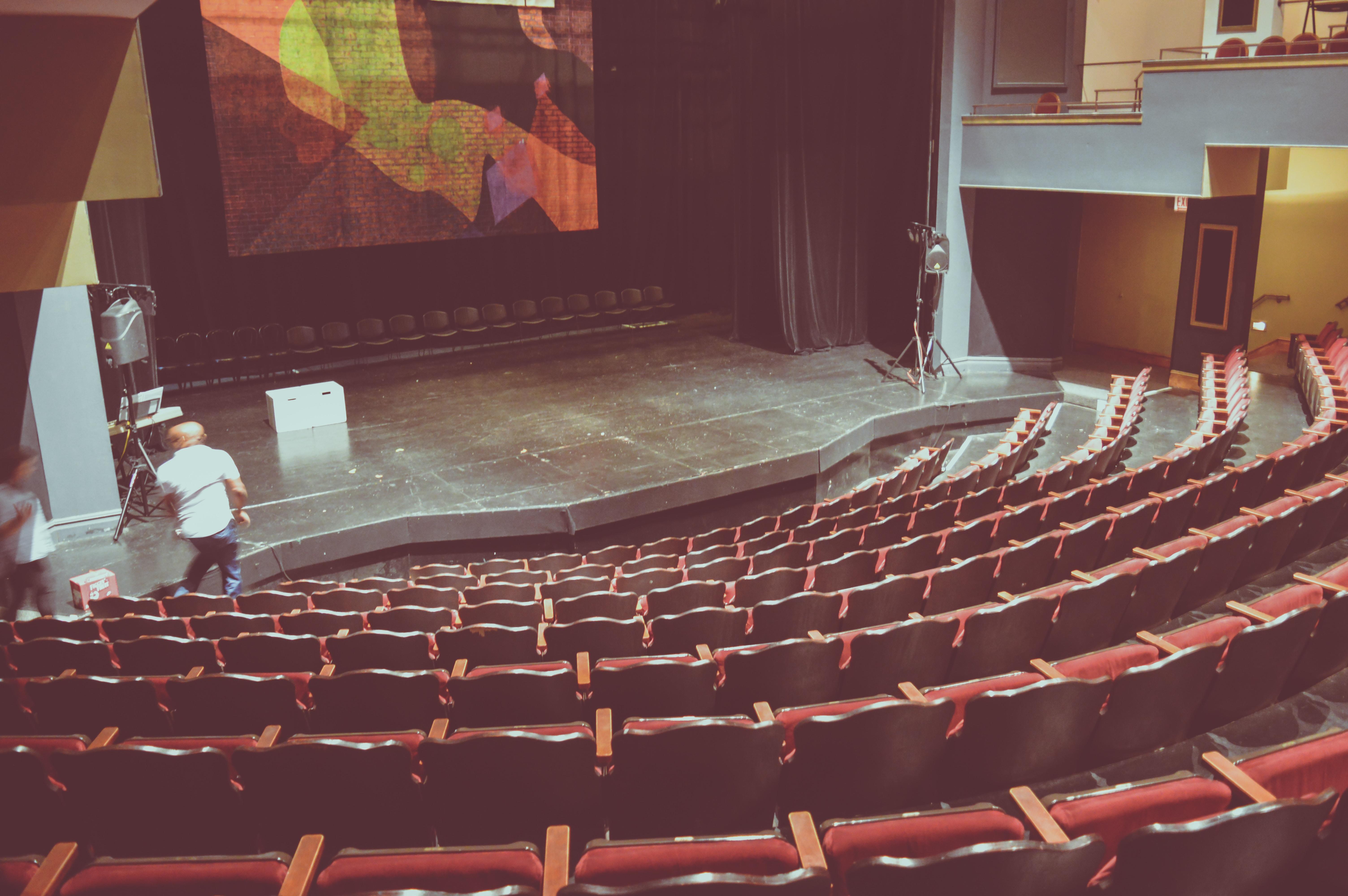 Rows of red theatres overlooking a main theatre stage.