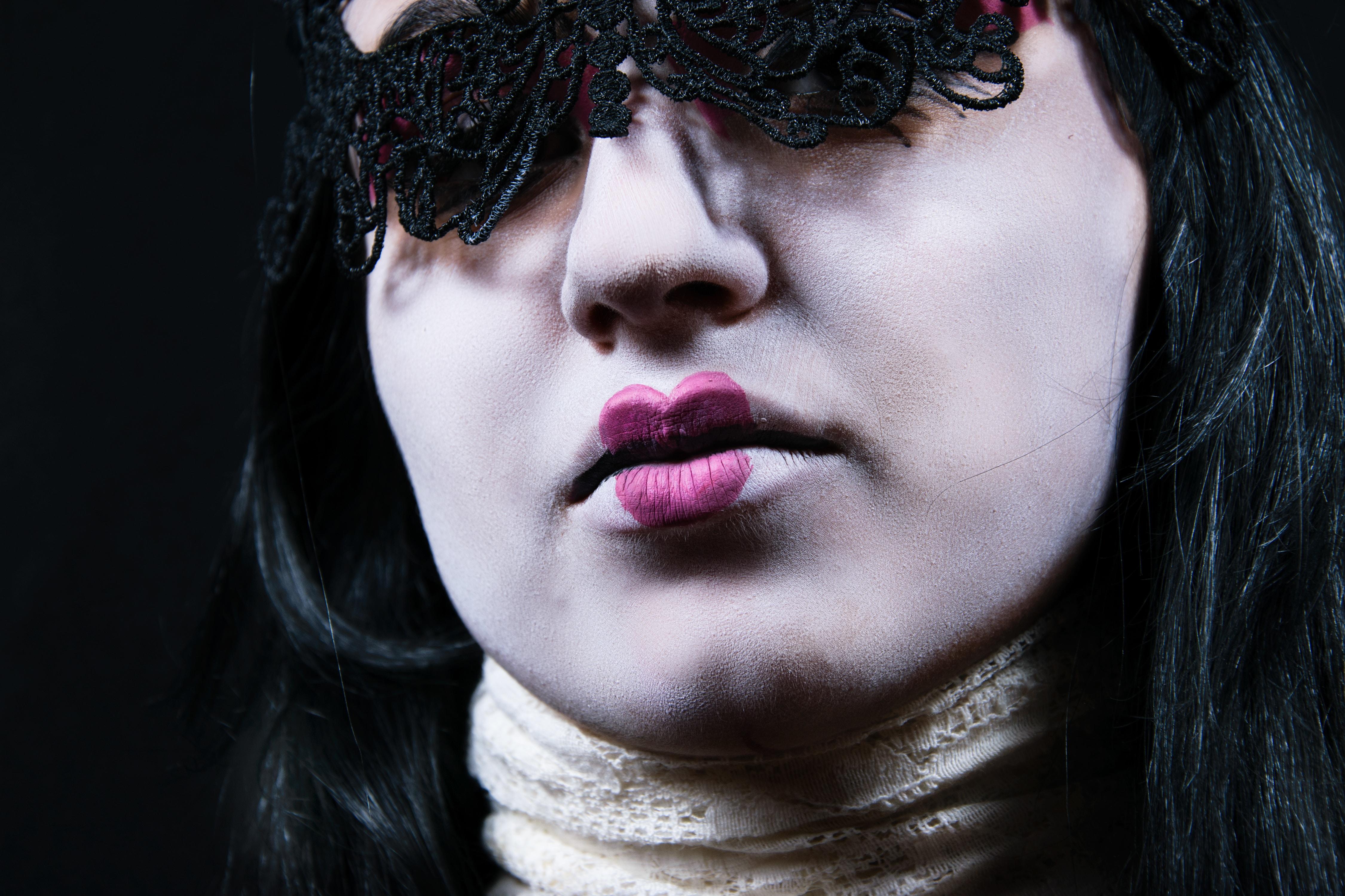 Closeup photograph of a women's face in a gothic costume.