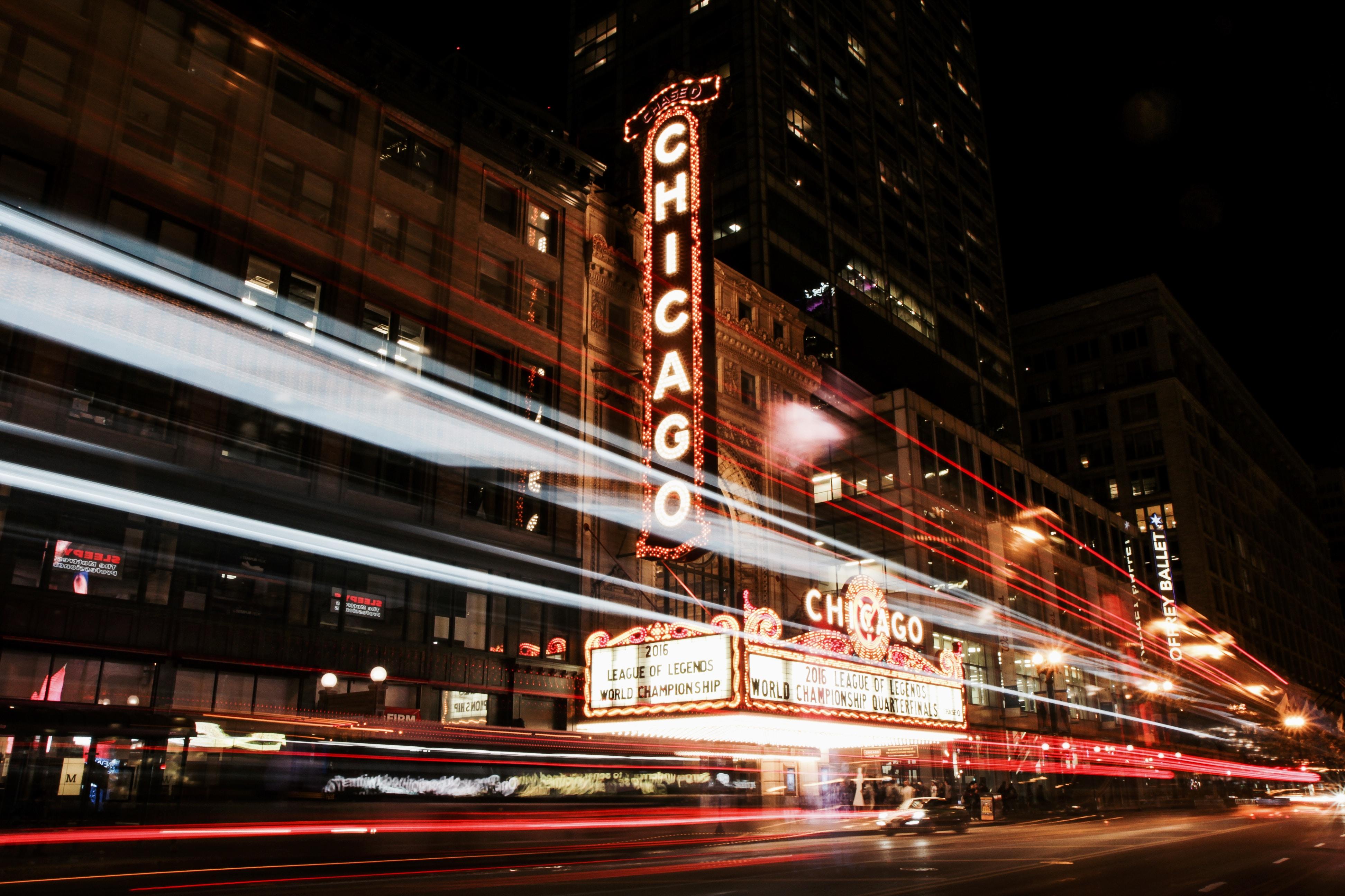 Chicago sign in front of a theatre at night.