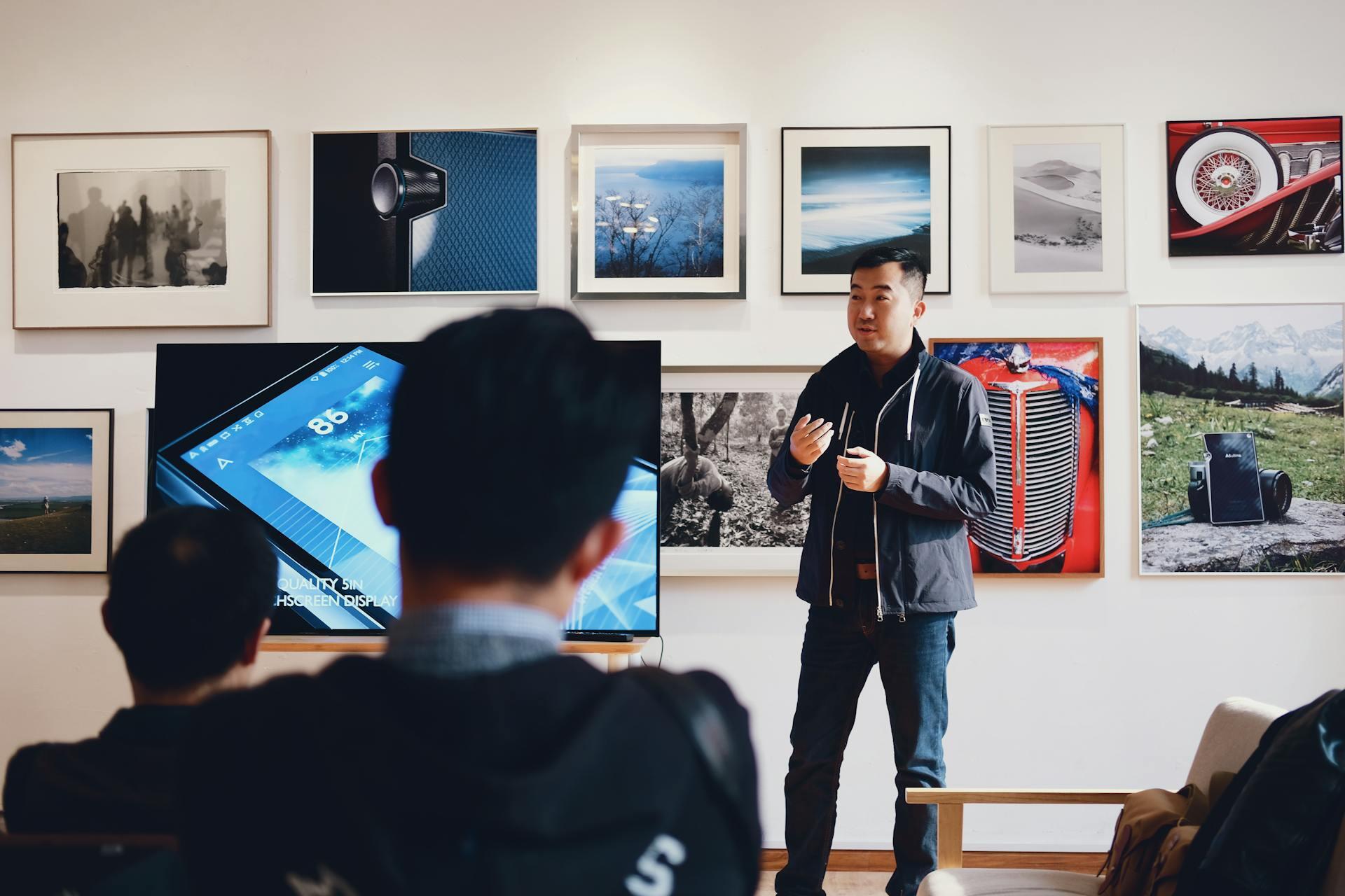 A man speaking in front of a group of people.
