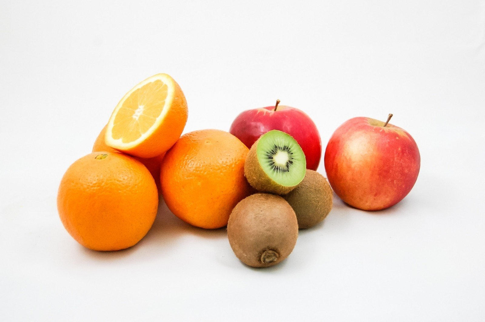 mix of fruits such as oranges, apples and kiwis
